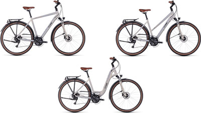Tres bicicletas Cube Touring Pro una al lado de la otra: una con cuadro diamante, otra con cuadro trapezoidal y otra con cuadro bajo.